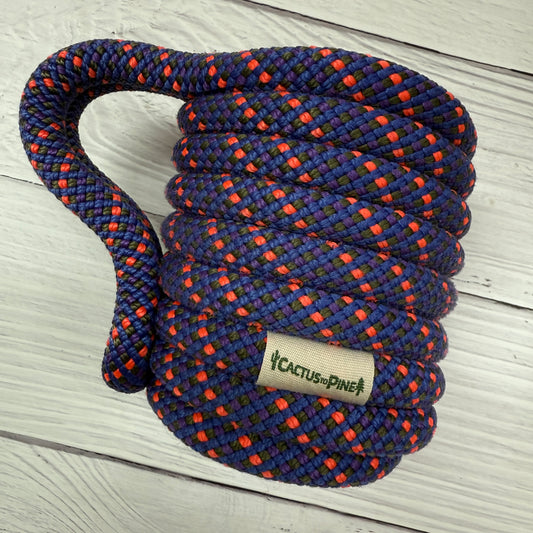 A coiled rope with a label that reads "Cactus Pine" is shown on a wooden surface.